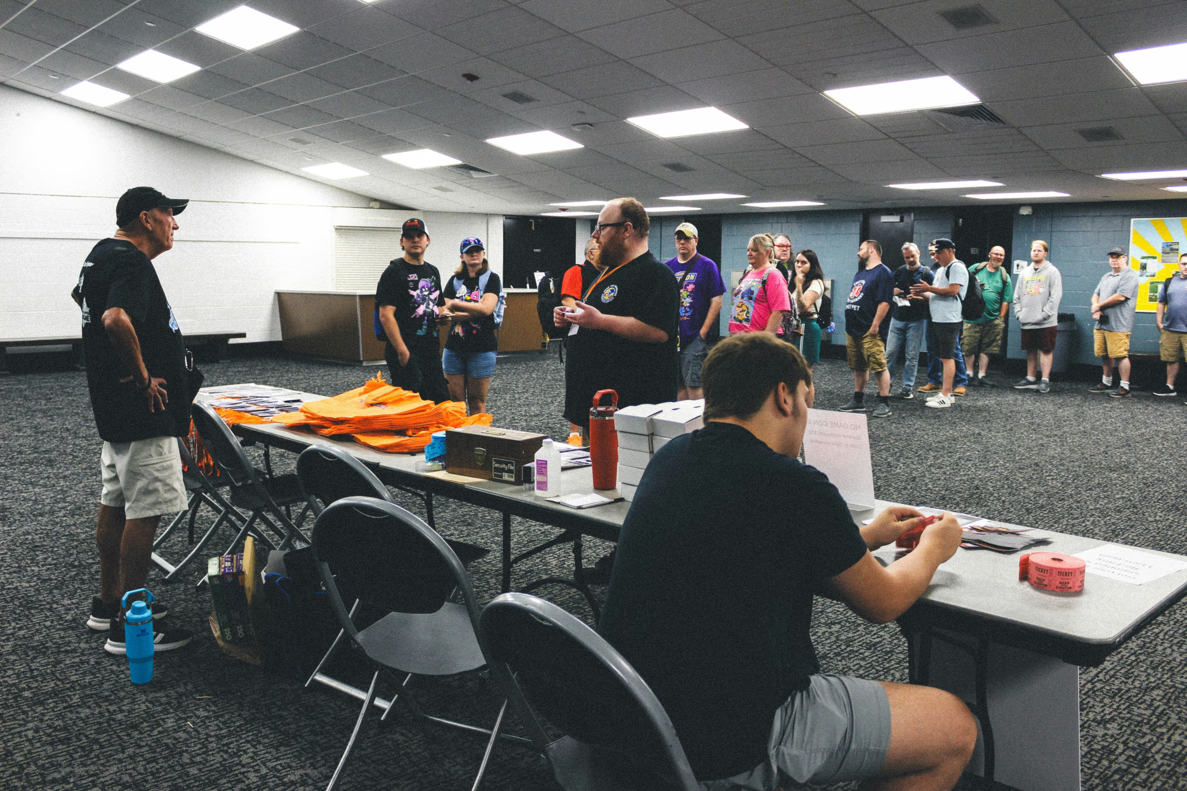 Attendees lined up at an event registration desk